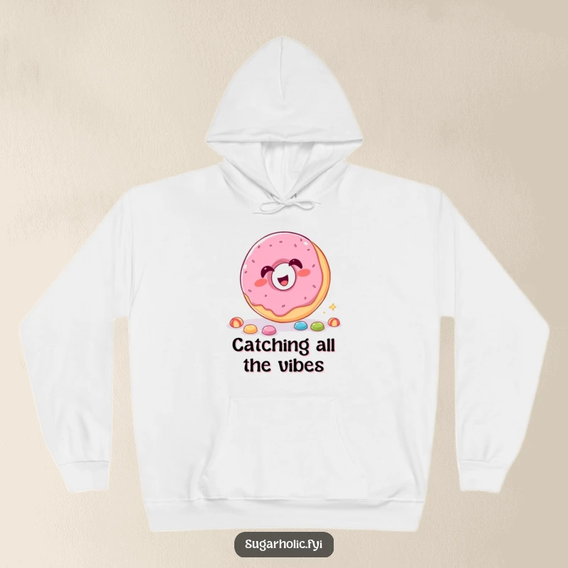 Funny Hoodie with a giggling donut catching candy through its hole, offering cozy humor.