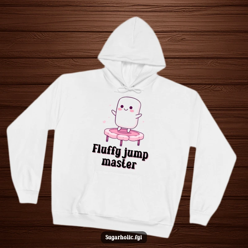 Funny hoodie depicting a smiling marshmallow character bouncing on a candy floss trampoline, offering cozy warmth and sweet, playful humor.