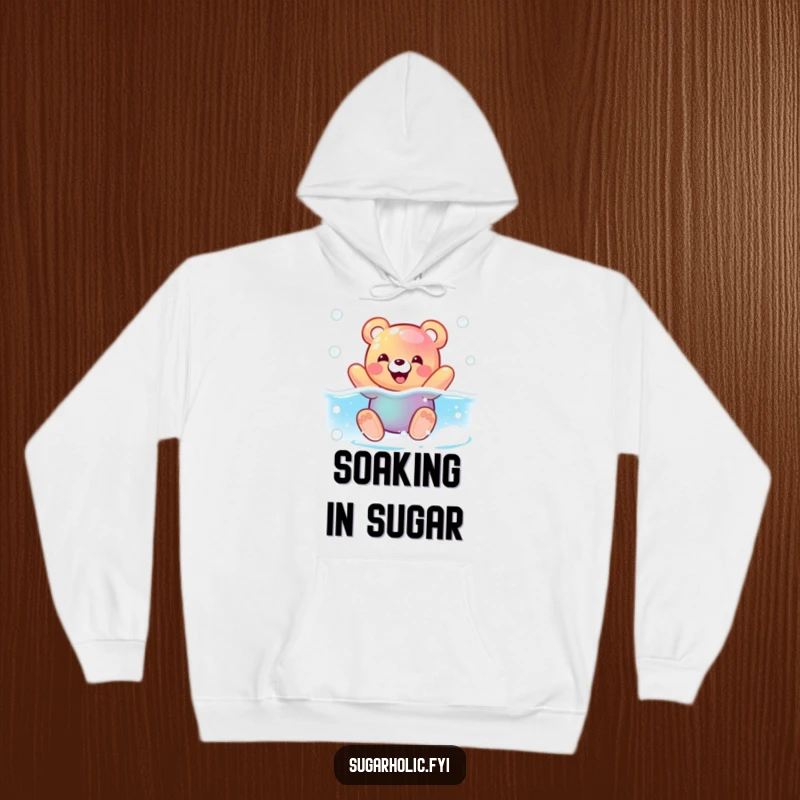 Funny hoodie with a pleased gummy bear character swimming in a fizzy soda pool, offering cozy and humorous wear.