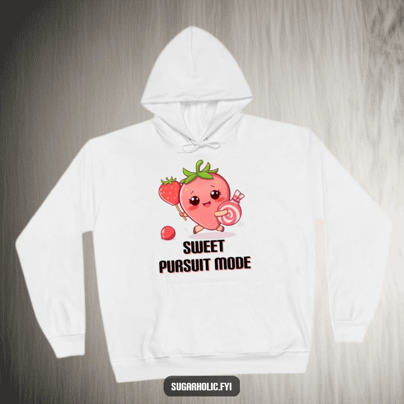 Funny hoodie with a blushing strawberry character hilariously chasing a piece of candy that has escaped, capturing a moment of sweet panic.