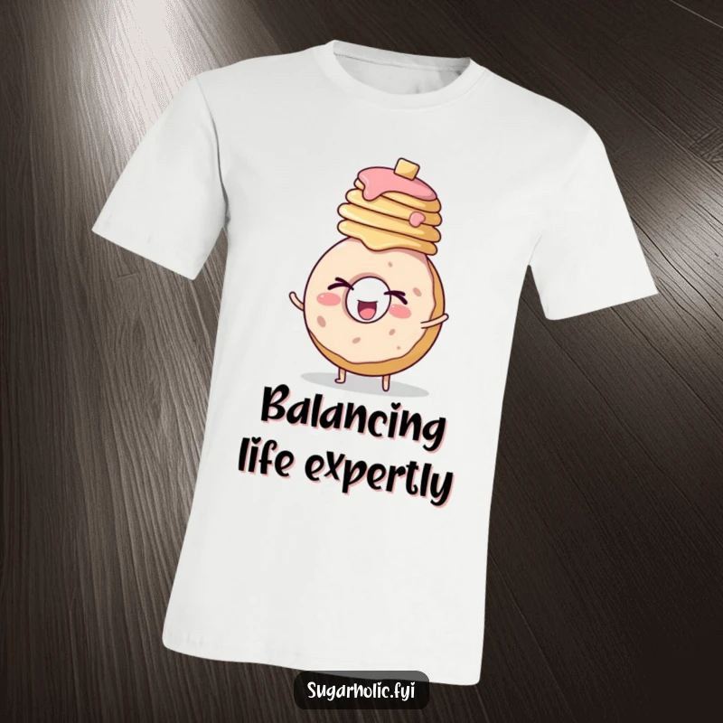 Funny t-shirt graphic of a round donut character enthusiastically winking while expertly balancing a stack of golden pancakes.